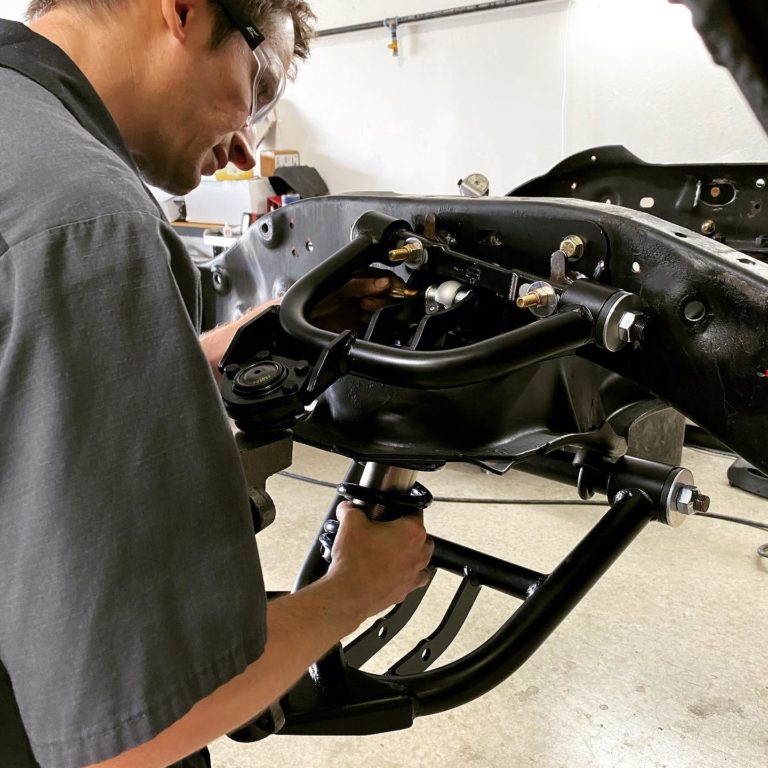 An automotive repair technician checking out the chassis suspension; steering and suspension in Gilbert, AZ