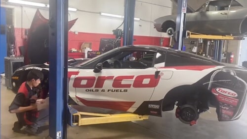 When to Make Auto Repair in Gilbert, AZ a Top Priority with Ace Performance Automotive, image of technician at the shop working on Torco street car in shop bay