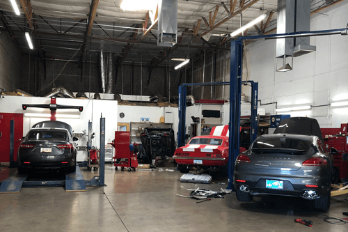 Four Signs You Found The Right Auto Repair Shop | APA Total Care in Gilbert, AZ. image of inside APA Gilbert shop bay with mixture of vehicles being serviced